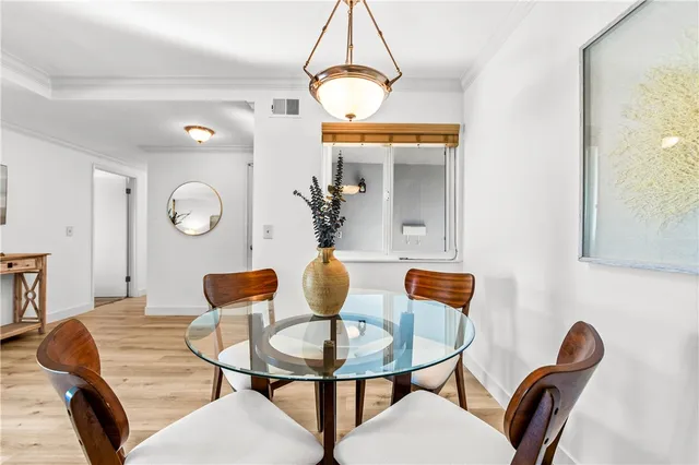a dining room with furniture and a mirror