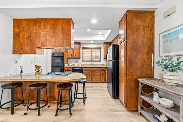 a kitchen with stainless steel appliances a table and chairs in it