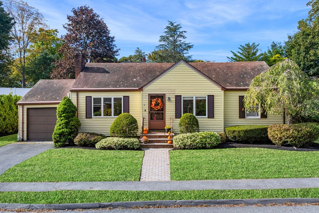 a front view of a house with a garden