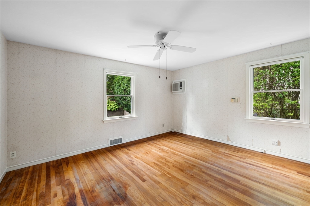 11 May Street Marblehead, MA 01945 - Photo 13 of 22 a view of an empty room with wooden floor and a window