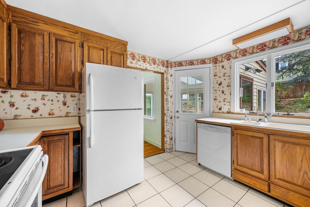 11 May Street Marblehead, MA 01945 - Photo 9 of 22 a kitchen with stainless steel appliances granite countertop a refrigerator and a sink