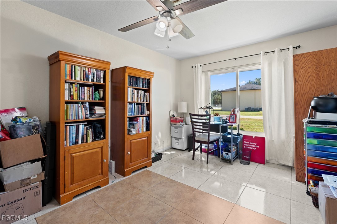 609 Gerald Avenue Lehigh Acres, FL 33936 - Photo 11 of 45 a view of a workspace with furniture and toys