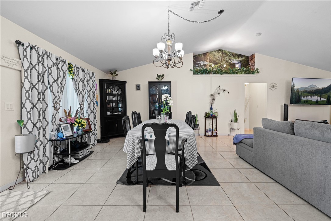 609 Gerald Avenue Lehigh Acres, FL 33936 - Photo 16 of 45 a living room with furniture a chandelier and a chandelier