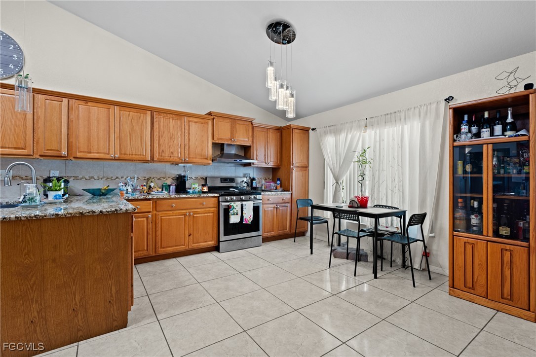 609 Gerald Avenue Lehigh Acres, FL 33936 - Photo 19 of 45 a kitchen with cabinets a sink and appliances