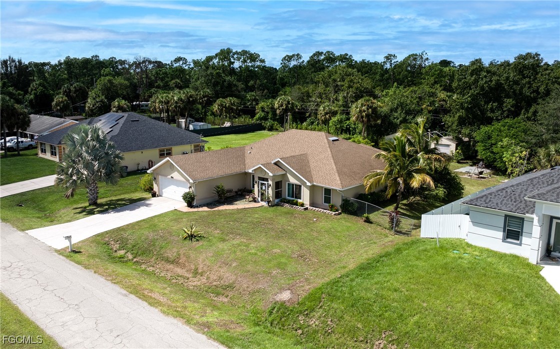 609 Gerald Avenue Lehigh Acres, FL 33936 - Photo 2 of 45 an aerial view of a house with a yard