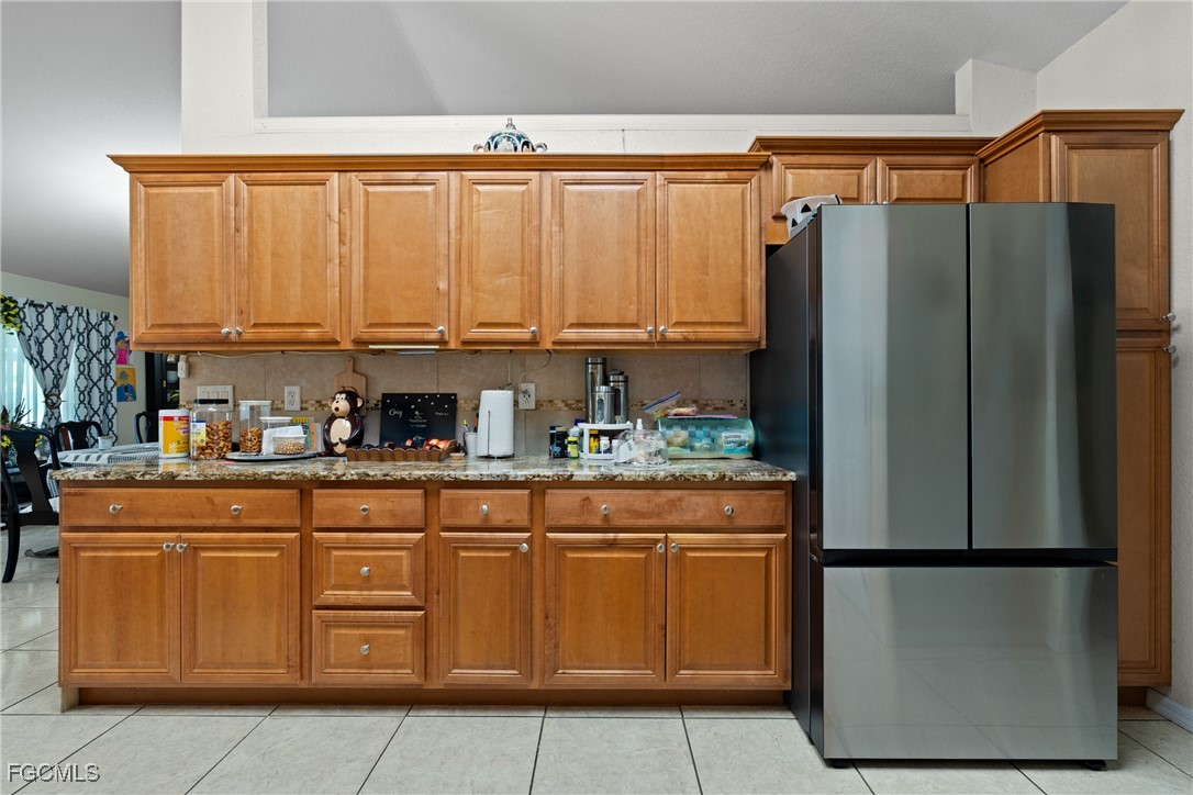 609 Gerald Avenue Lehigh Acres, FL 33936 - Photo 21 of 45 a kitchen with stainless steel appliances granite countertop a refrigerator and a stove