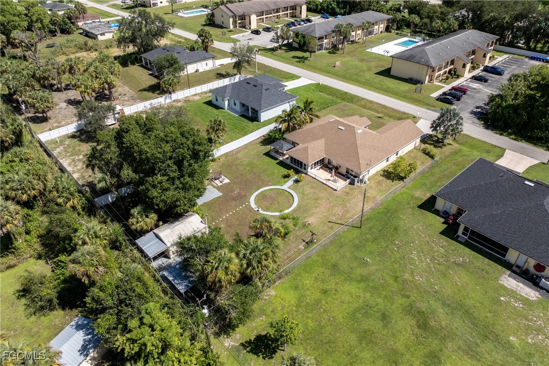 609 Gerald Avenue Lehigh Acres, FL 33936 - Photo 3 of 45 an aerial view of a house with a yard and lake