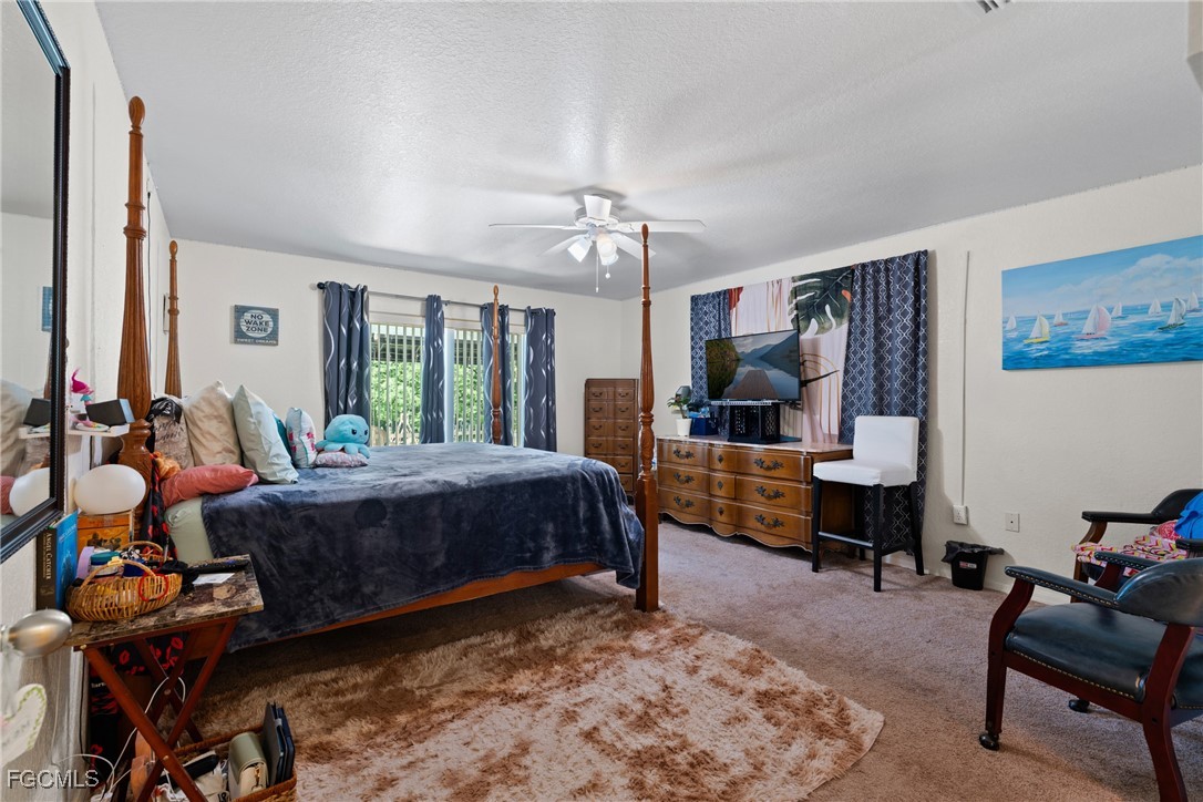 609 Gerald Avenue Lehigh Acres, FL 33936 - Photo 36 of 45 a bedroom with a bed and wooden floor