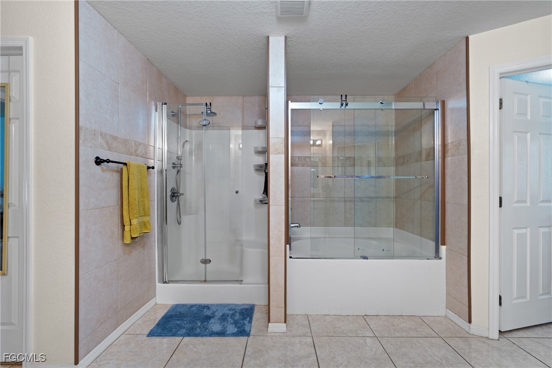 609 Gerald Avenue Lehigh Acres, FL 33936 - Photo 39 of 45 a bathroom with a shower and a bathtub