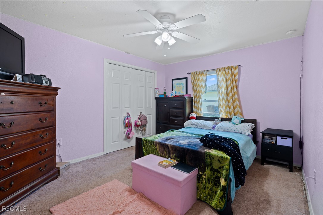 609 Gerald Avenue Lehigh Acres, FL 33936 - Photo 44 of 45 a bedroom with a bed and a dresser in it