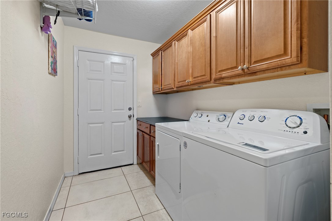 609 Gerald Avenue Lehigh Acres, FL 33936 - Photo 45 of 45 a utility room with dryer and washer