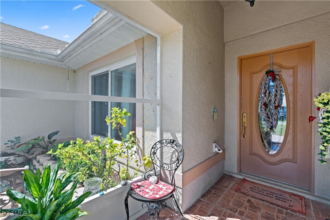 609 Gerald Avenue Lehigh Acres, FL 33936 - Photo 7 of 45 a living room with furniture and a potted plant