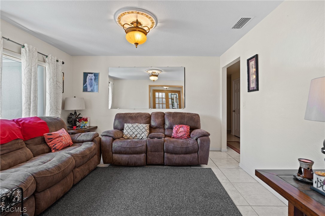 609 Gerald Avenue Lehigh Acres, FL 33936 - Photo 9 of 45 a living room with furniture and a couch