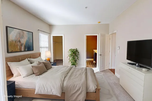 a bedroom with a bed and a flat screen tv