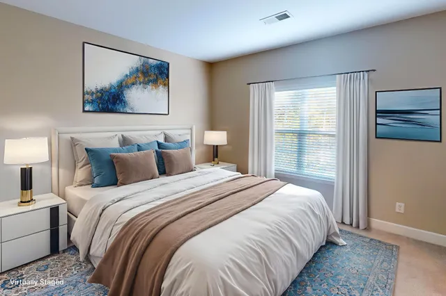 a bedroom with bed painting on the wall and a window