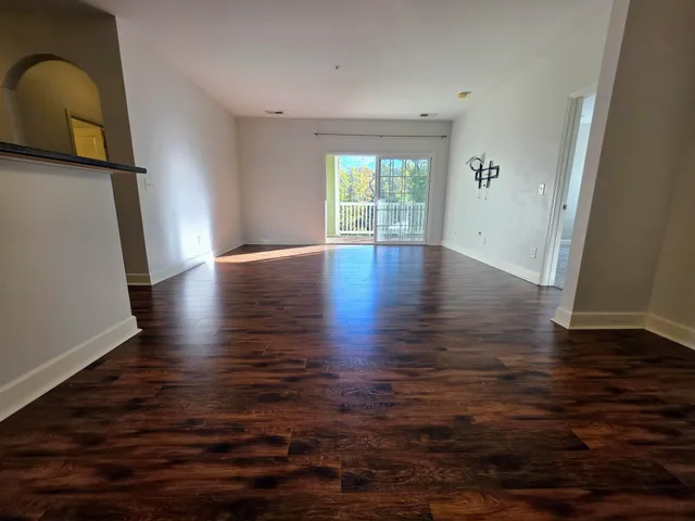 a view of room with hardwood floor and window