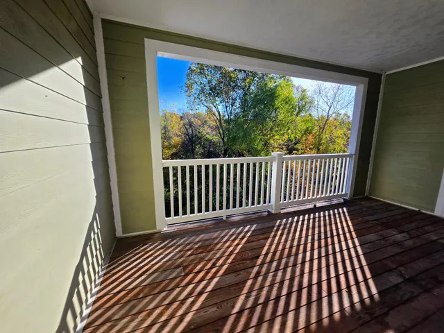 a view of a balcony with wooden floor