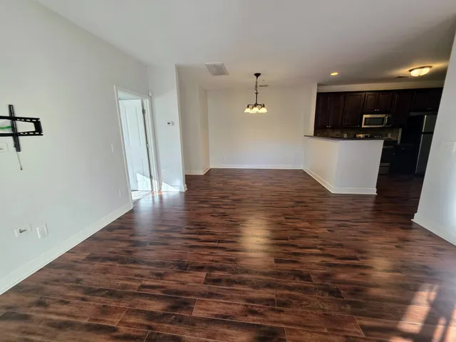 a view of a living room with wooden floor