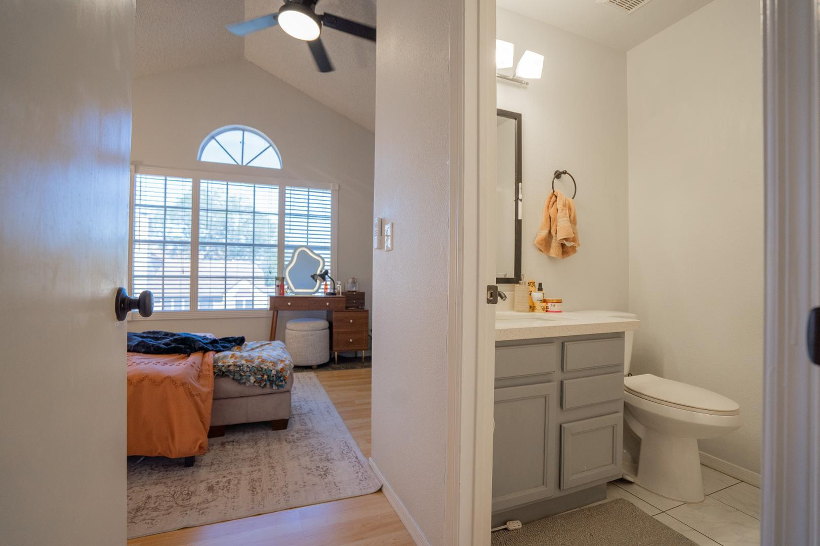 8111 West Wacker Road, Unit 70 Peoria, AZ 85381 - Photo 22 of 38 a en suite bathroom with a toilet sink and mirror