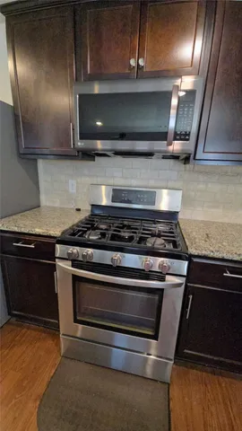 a stove top oven sitting inside of a kitchen