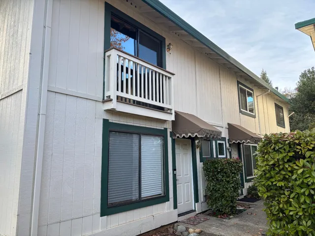 a front view of a house with iron fence