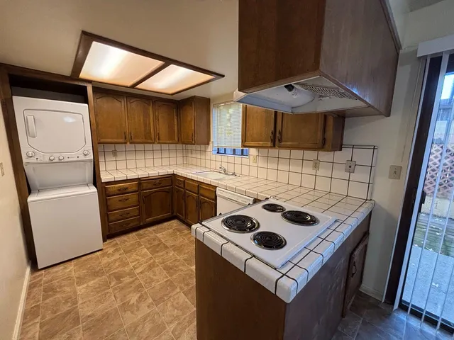 a kitchen with a sink appliances and cabinets