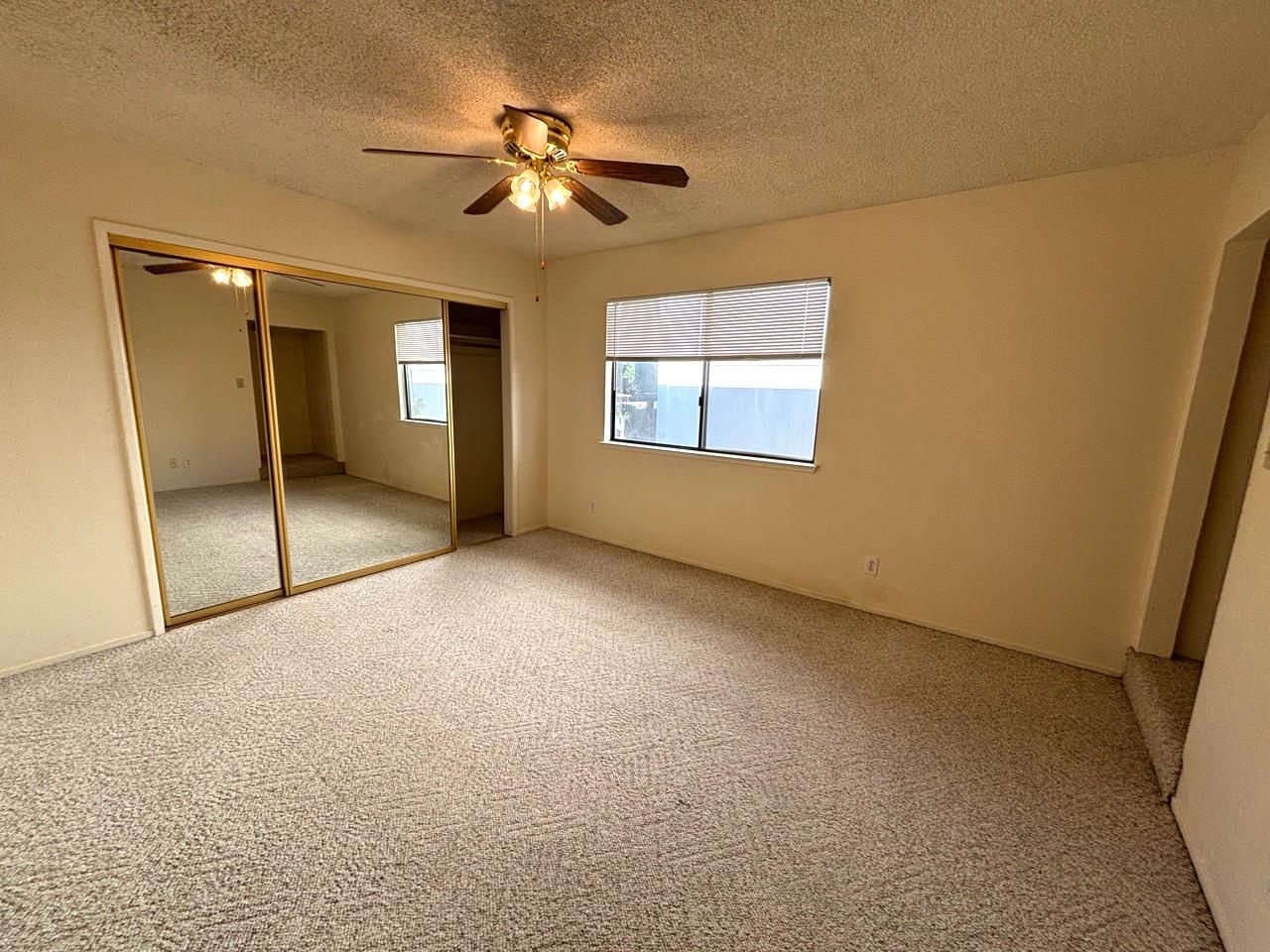3579 Cedar Ravine Road Placerville, CA 95667 - Photo 7 of 15 an empty room with chandelier fan and windows