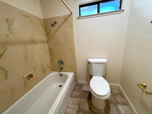 a bathroom with a toilet and a sink