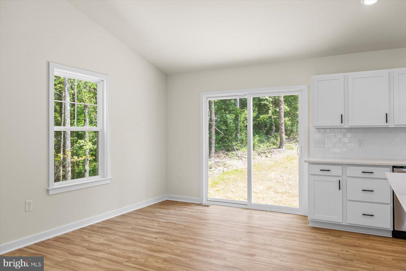 3319 Partlow Road Partlow, VA 22534 - Photo 17 of 47 an empty room with wooden floor and windows
