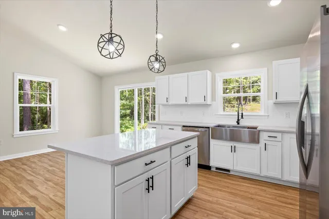 a kitchen with granite countertop a sink and a stove