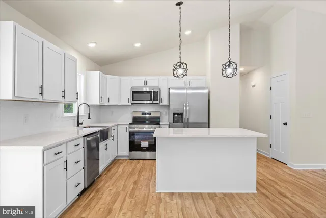 a kitchen with a sink stove and refrigerator