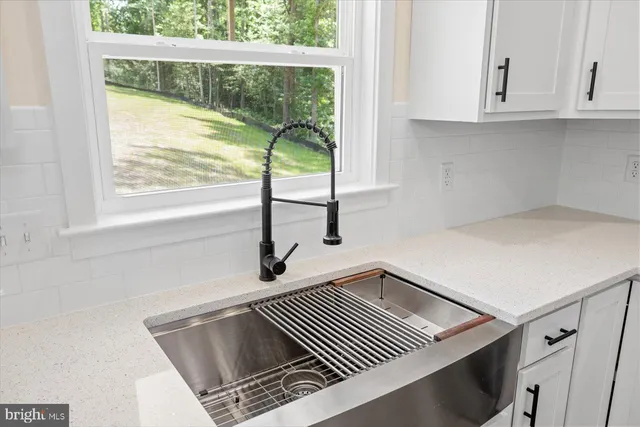a kitchen with stainless steel appliances a refrigerator and cabinets