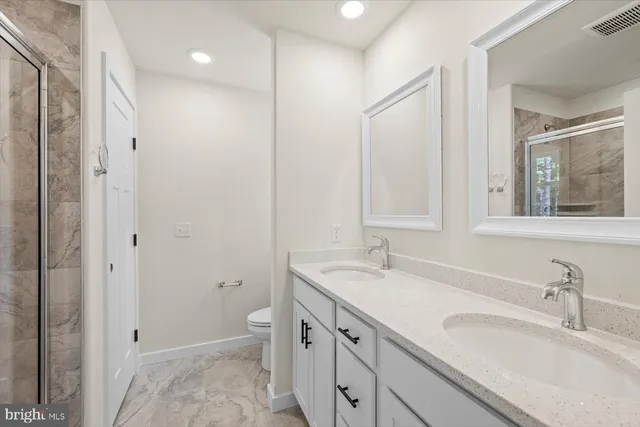a bathroom with a shower sink and mirror
