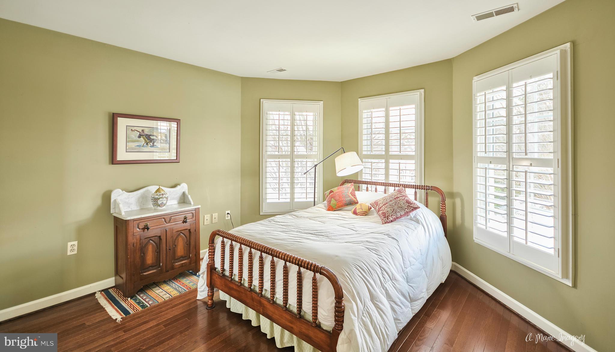 2498-5 Five Shillings Road Frederick, MD 21701 - Photo 22 of 30 a bedroom with a bed and wooden floor