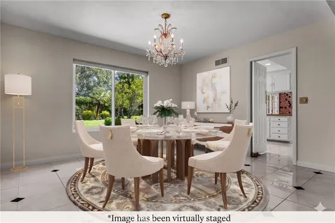 a view of a dining room with furniture a chandelier and wooden floor