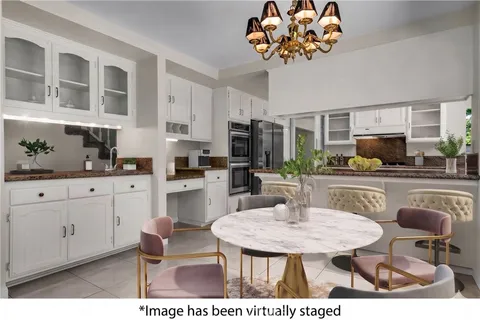 a kitchen with a table chairs stove and microwave