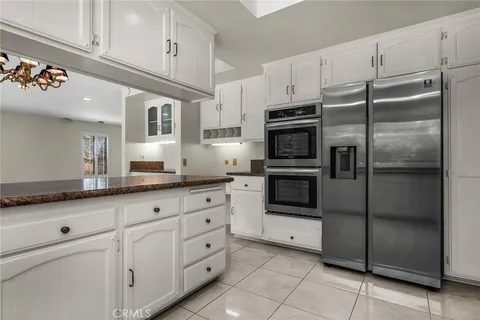 a kitchen with granite countertop cabinets and stainless steel appliances