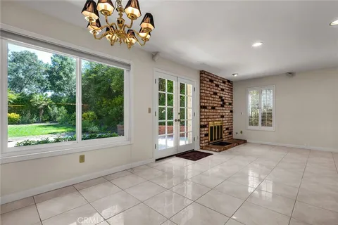 a view of an empty room with a window and a ceiling fan