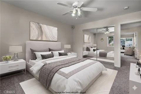 a bedroom with a bed and ceiling fan