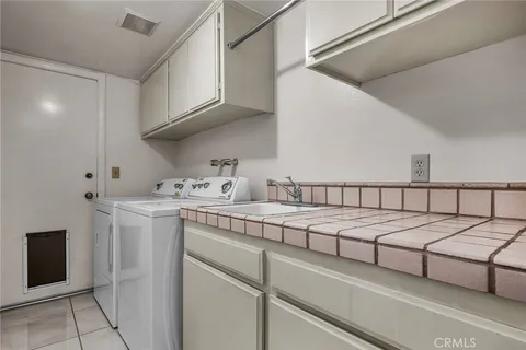 a spacious bathroom with a double vanity sink and a mirror