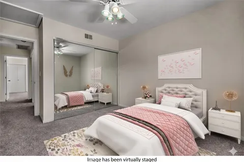 a bedroom with bed and a chandelier
