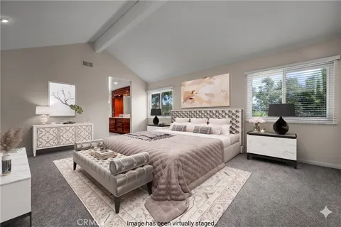 a bedroom with bed and a large window
