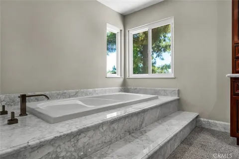 a spacious bathroom with a tub and a sink