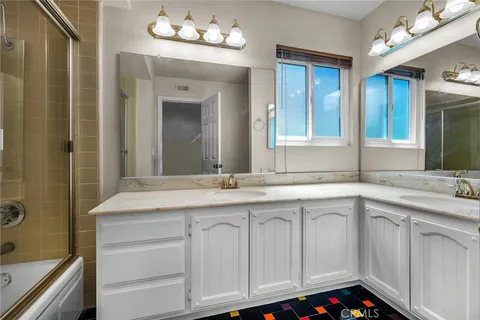 a bathroom with a sink vanity and mirror