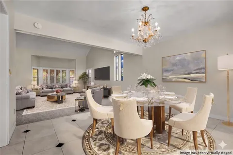 a view of a dining room with furniture wooden floor and chandelier