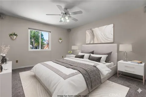 a bedroom with a large bed and a window