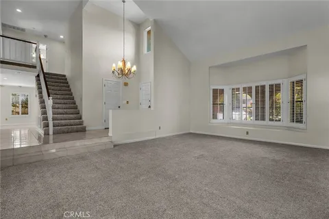a view of an empty room with stairs