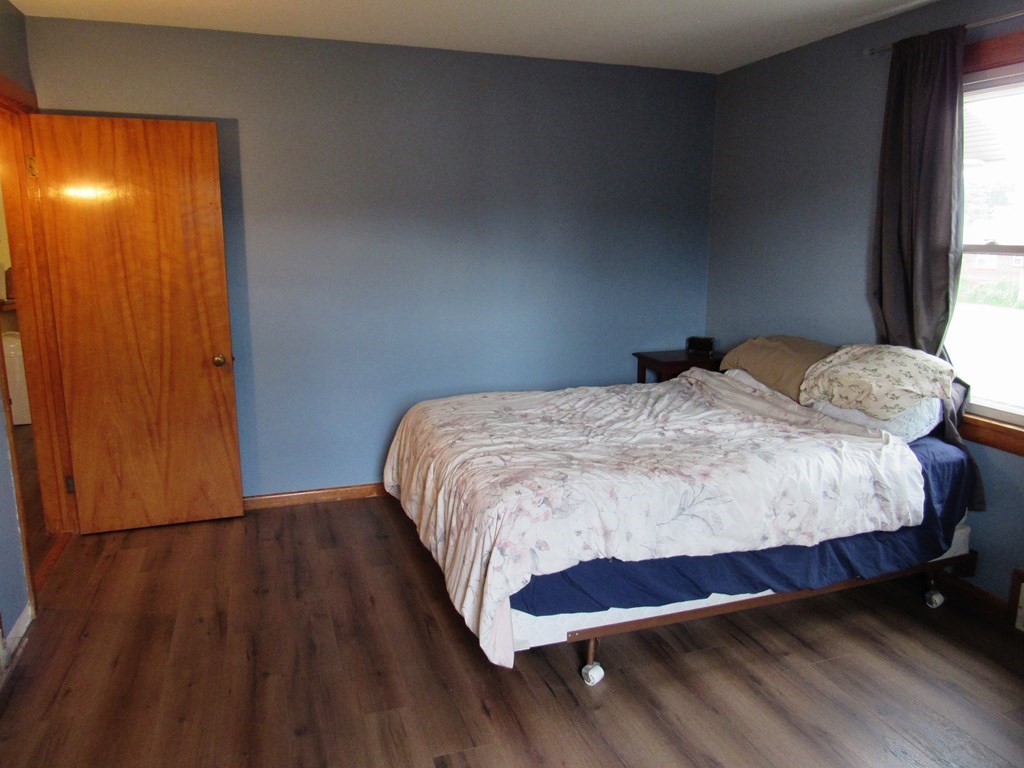 2340 Main Street Three Rivers, MA 01080 - Photo 18 of 31 a bedroom with a bed and wooden floor