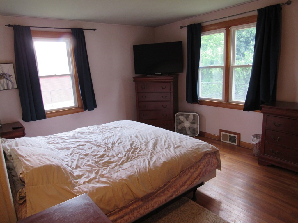 2340 Main Street Three Rivers, MA 01080 - Photo 22 of 31 a bedroom with a bed and a flat tv screen on a dresser