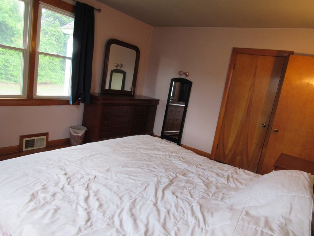 2340 Main Street Three Rivers, MA 01080 - Photo 24 of 31 a bedroom with a bed and wooden floor